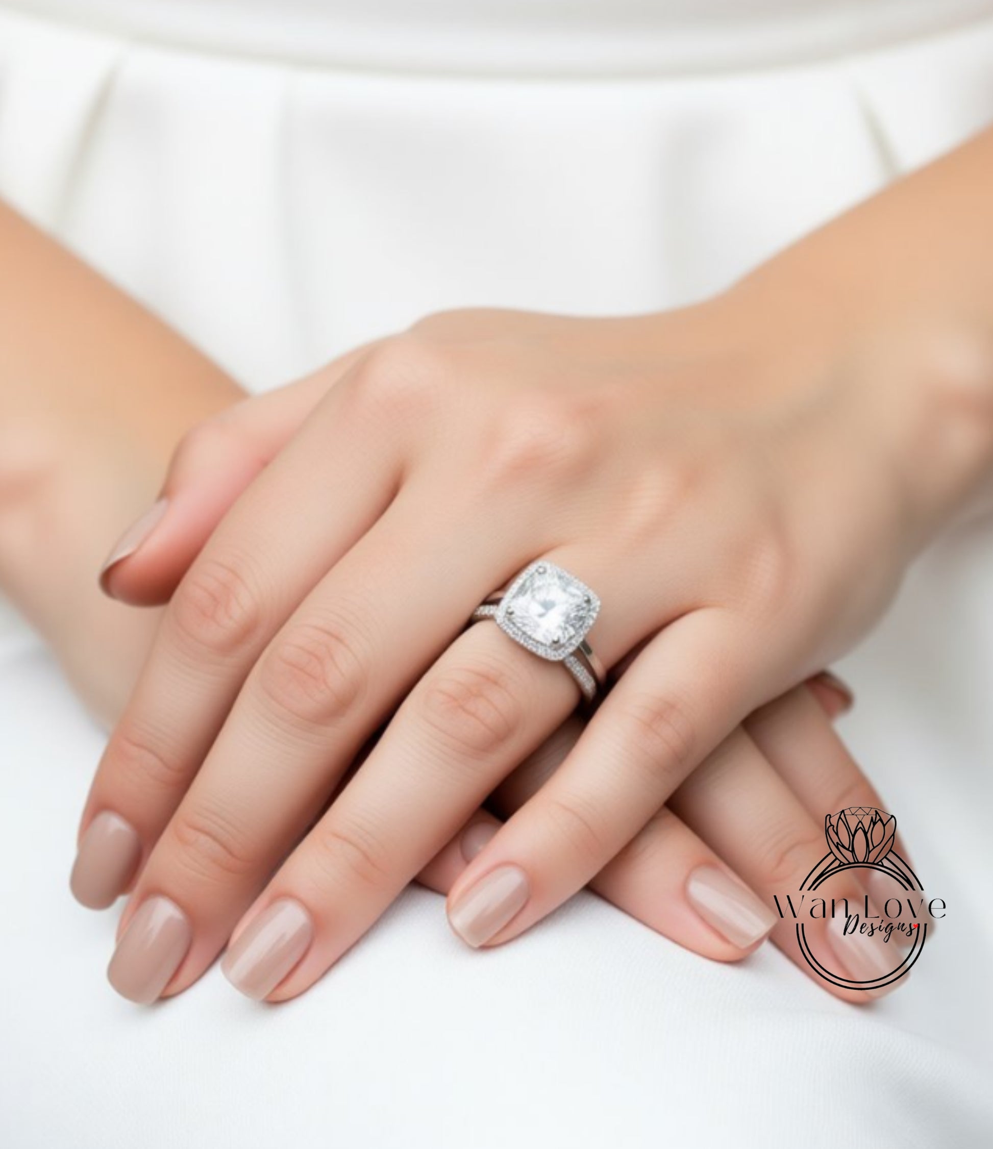 A close-up of a person's hands wearing a large diamond engagement ring.