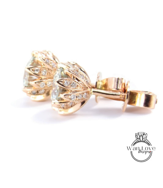 A pair of gold earrings with a floral design and small diamonds set in the center.
