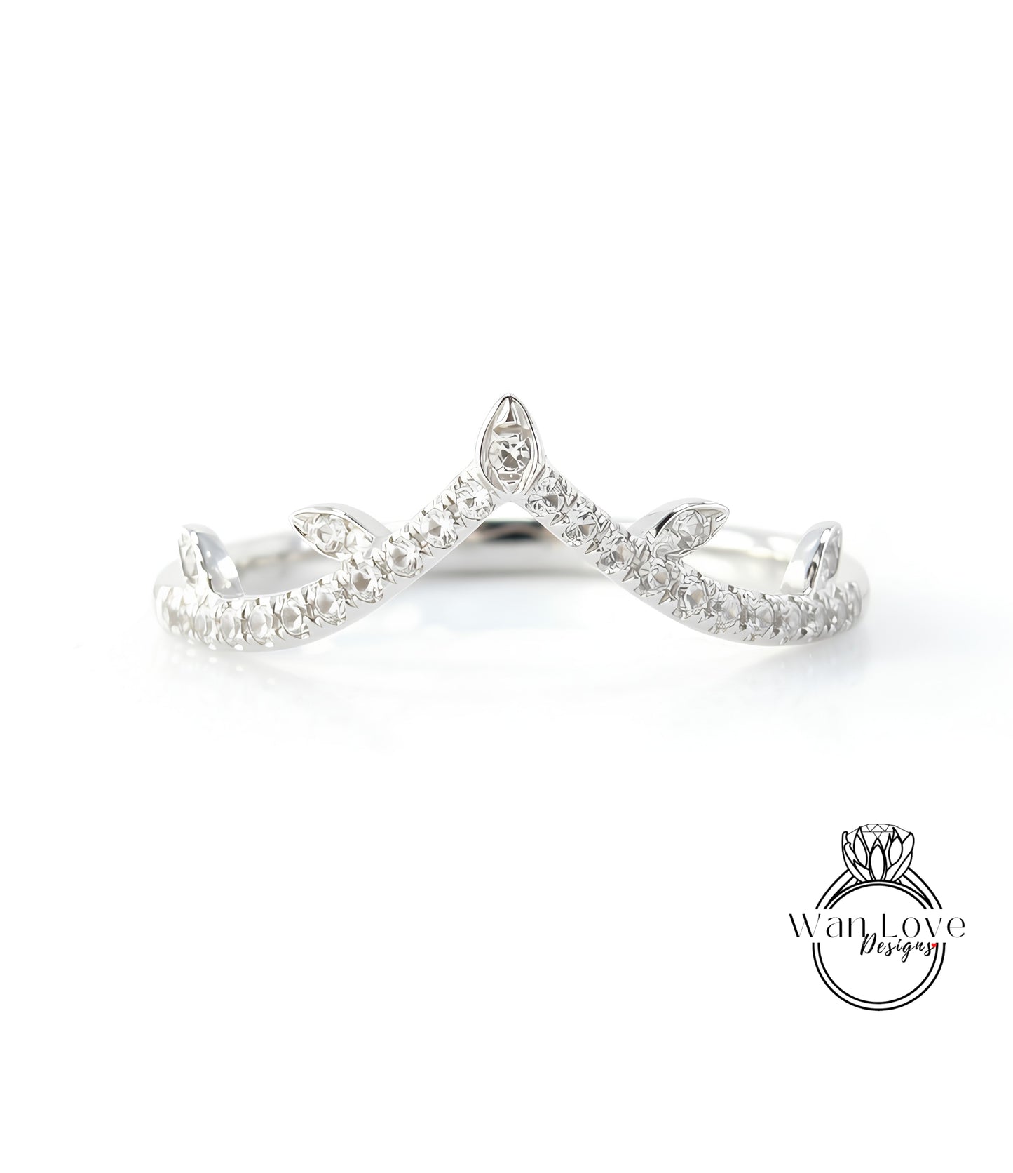 A silver ring with a diamond-encrusted crown-like design.