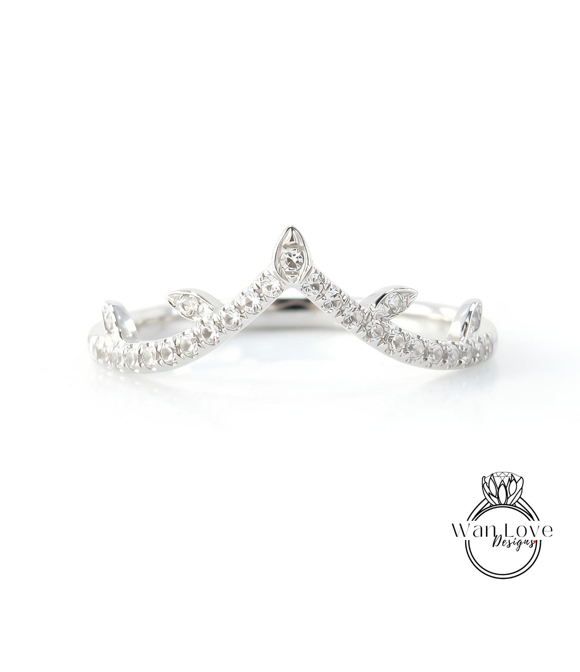 A silver ring with a diamond-encrusted crown-like design.
