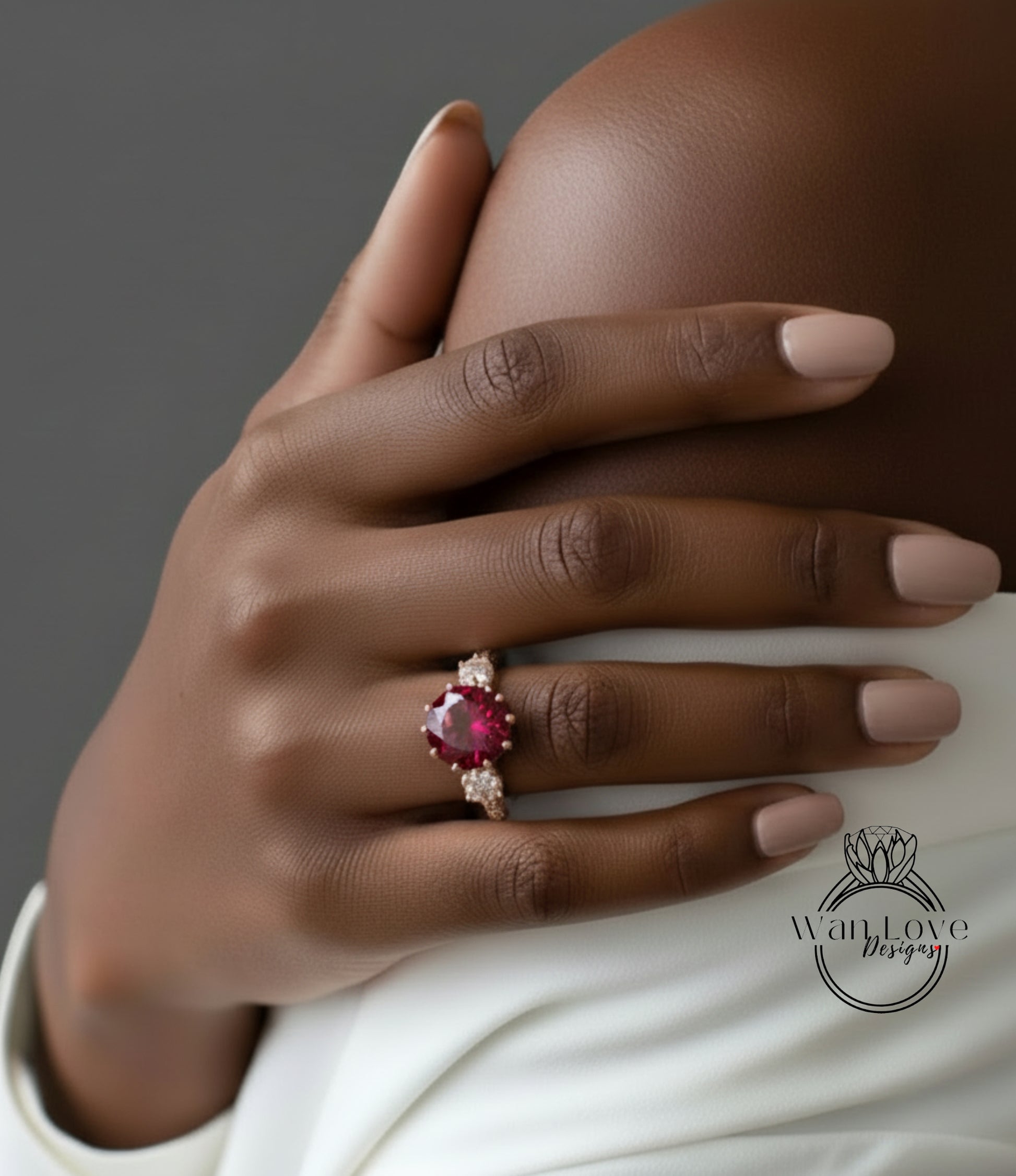 A close-up of a hand wearing a ring with a large red gemstone.