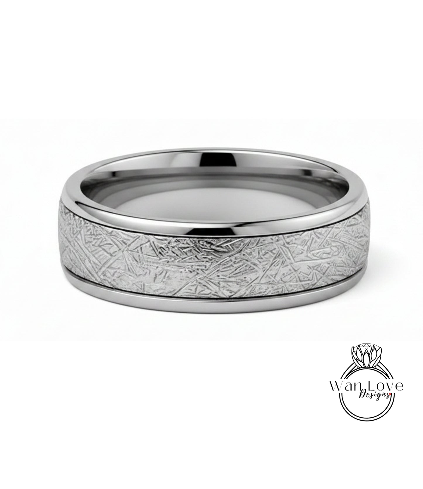 A silver ring with a textured band featuring a metallic, abstract design.