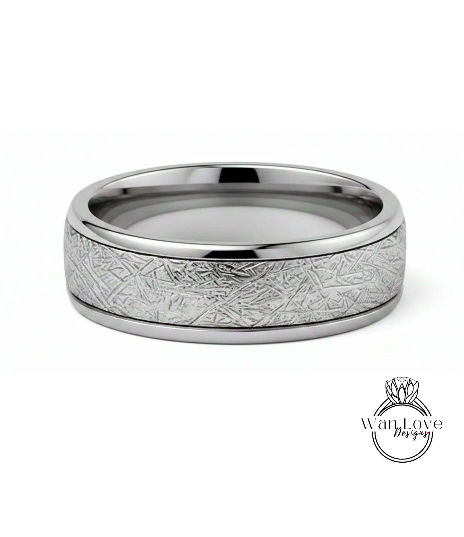 A silver ring with a textured band featuring a metallic, abstract design.