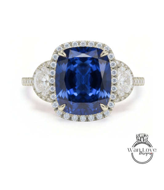 A stunning blue sapphire engagement ring with a halo of diamonds around the center stone.