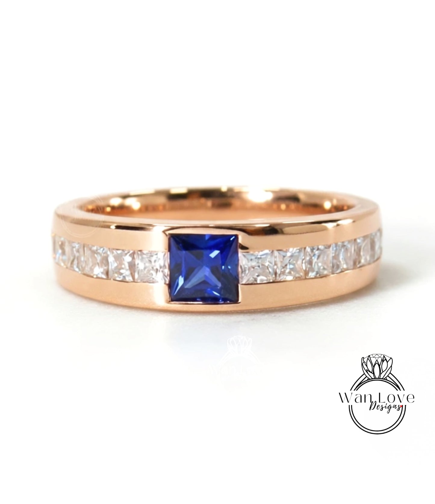 A gold ring with a blue gemstone in the center, surrounded by smaller diamonds.