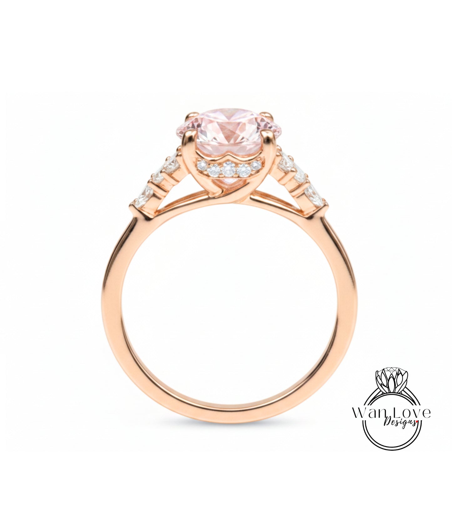 A gold ring with a large pink gemstone, possibly a diamond, set in the center.