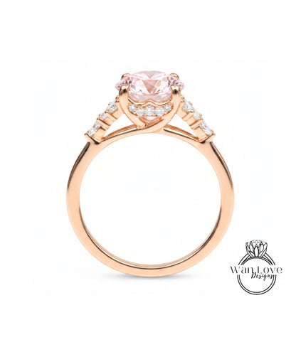 A gold ring with a large pink gemstone, possibly a diamond, set in the center.