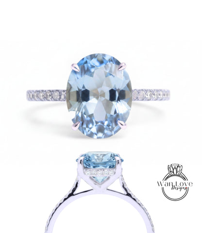 A stunning blue aquamarine gemstone engagement ring with a delicate band and sparkling diamonds.