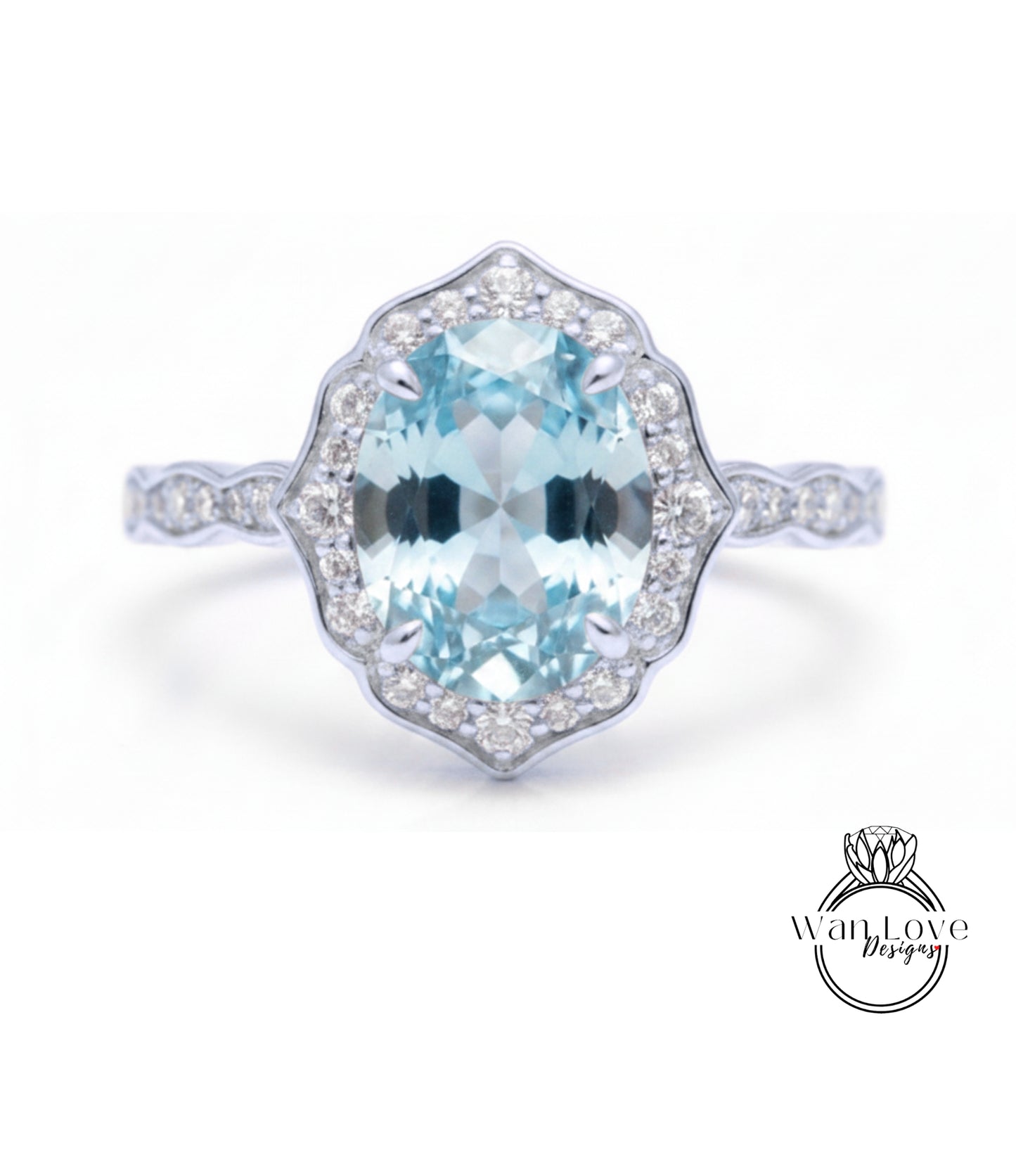 A stunning light blue gemstone ring with a halo of smaller diamonds around the center stone.