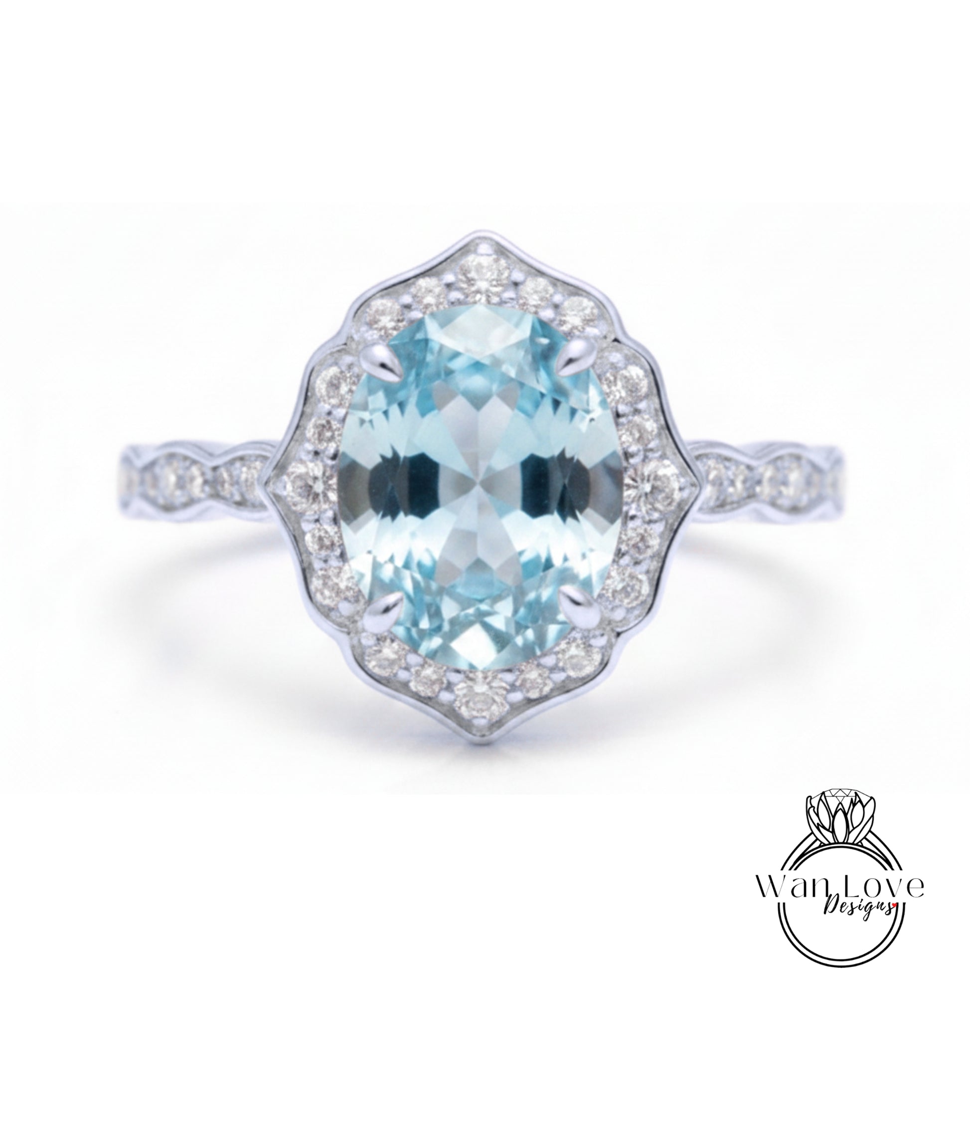 A stunning light blue gemstone ring with a halo of smaller diamonds around the center stone.