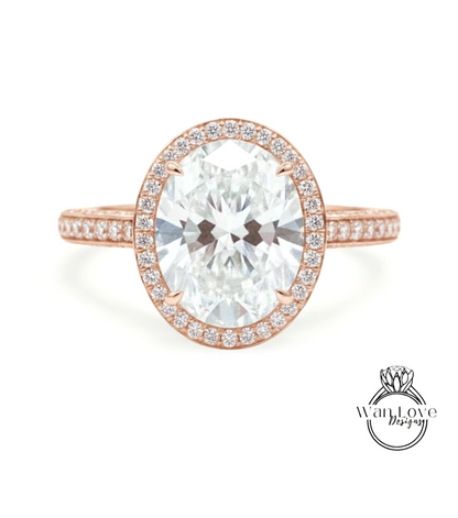 a beautiful rose gold ring with a large oval-shaped diamond set in the center, surrounded by a halo of smaller diamonds.