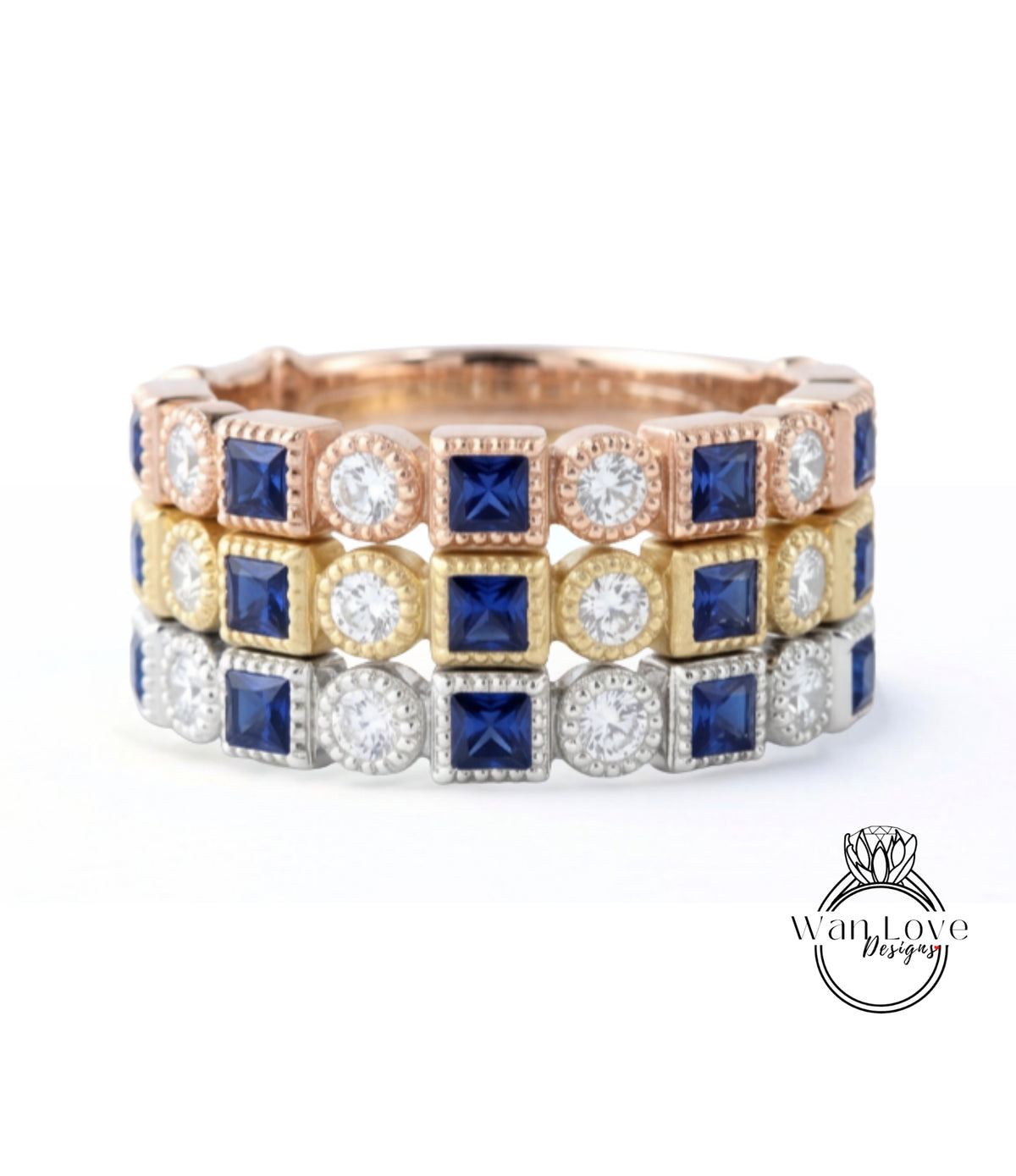 A ring with three concentric bands, each with a different type of gemstone. The top band is gold, the middle band is silver, and the bottom band is blue.