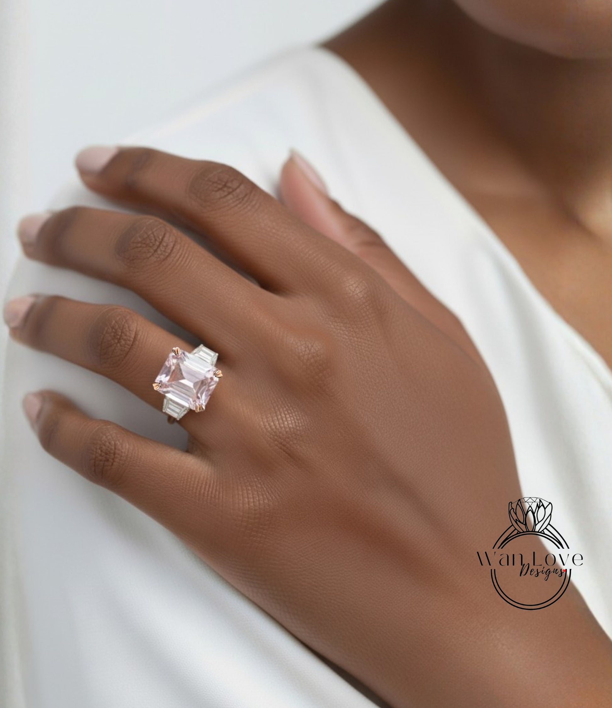 A close-up of a person's hand wearing a large, pink gemstone ring on the ring finger.
