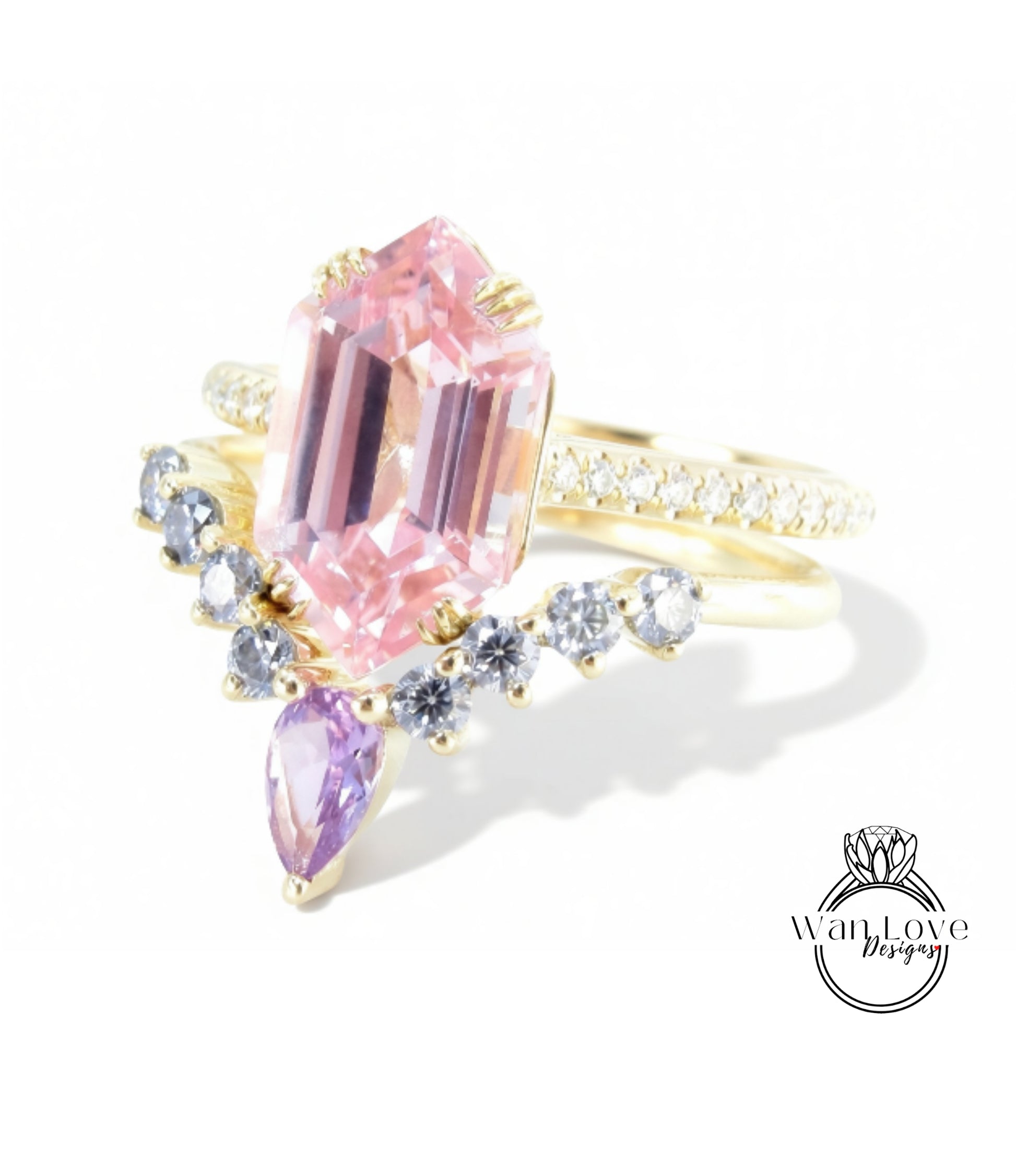 A gold ring with a large pink gemstone and smaller purple gemstones, set against a white background.
