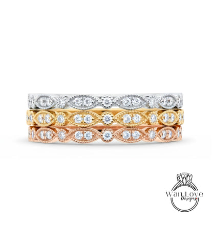 A stack of three rings with different colored gemstones set in the center.
