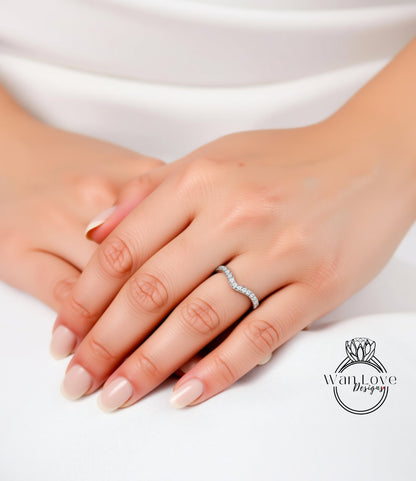 A close-up image of a person's hands wearing a diamond ring on the ring finger.