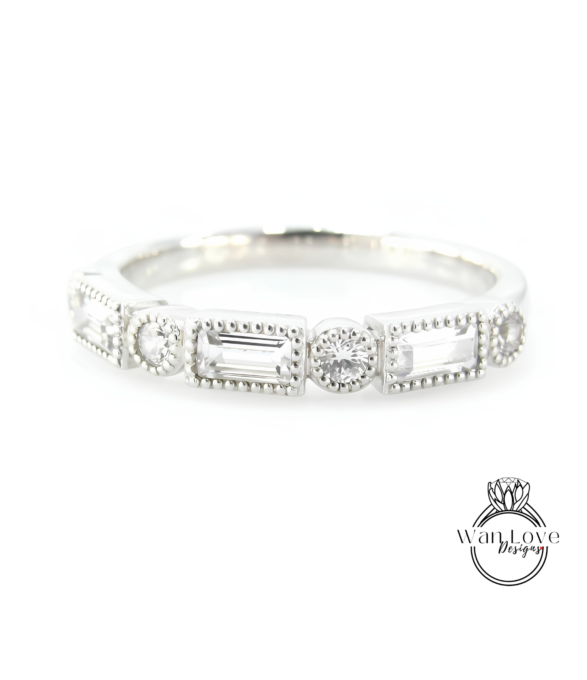 A silver ring with a row of rectangular and square-shaped diamonds set in the center.