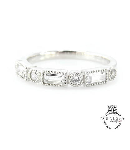 A silver ring with a row of rectangular and square-shaped diamonds set in the center.