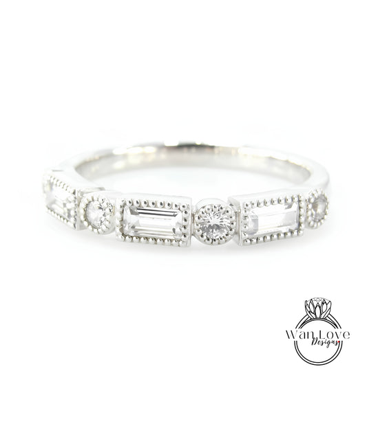 A silver ring with a row of rectangular and square-shaped diamonds set in the center.