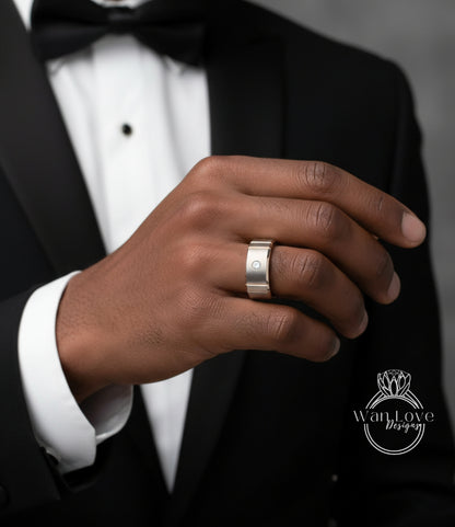 A close-up of a person's hand wearing a ring, with a black suit jacket visible in the background.