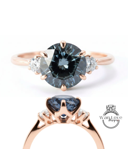 a rose gold ring with a large blue gemstone set in the center, surrounded by smaller diamonds.