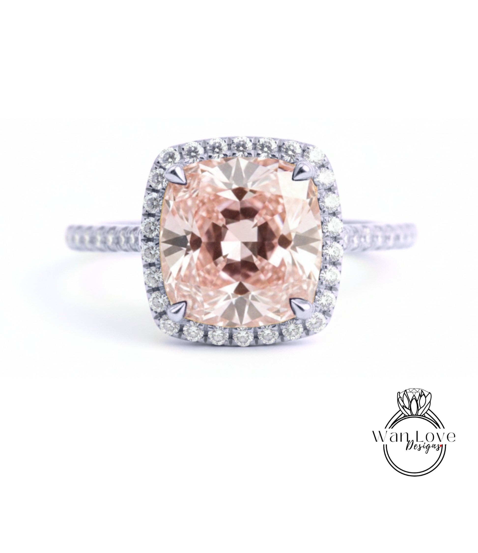 A large, pink diamond ring with a halo of smaller diamonds around the center stone.