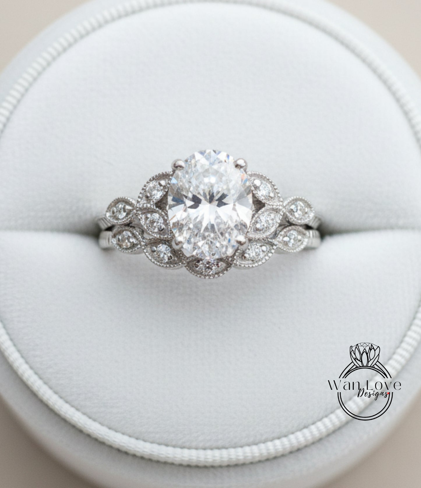 A close-up view of a diamond engagement ring displayed in a white jewelry box.