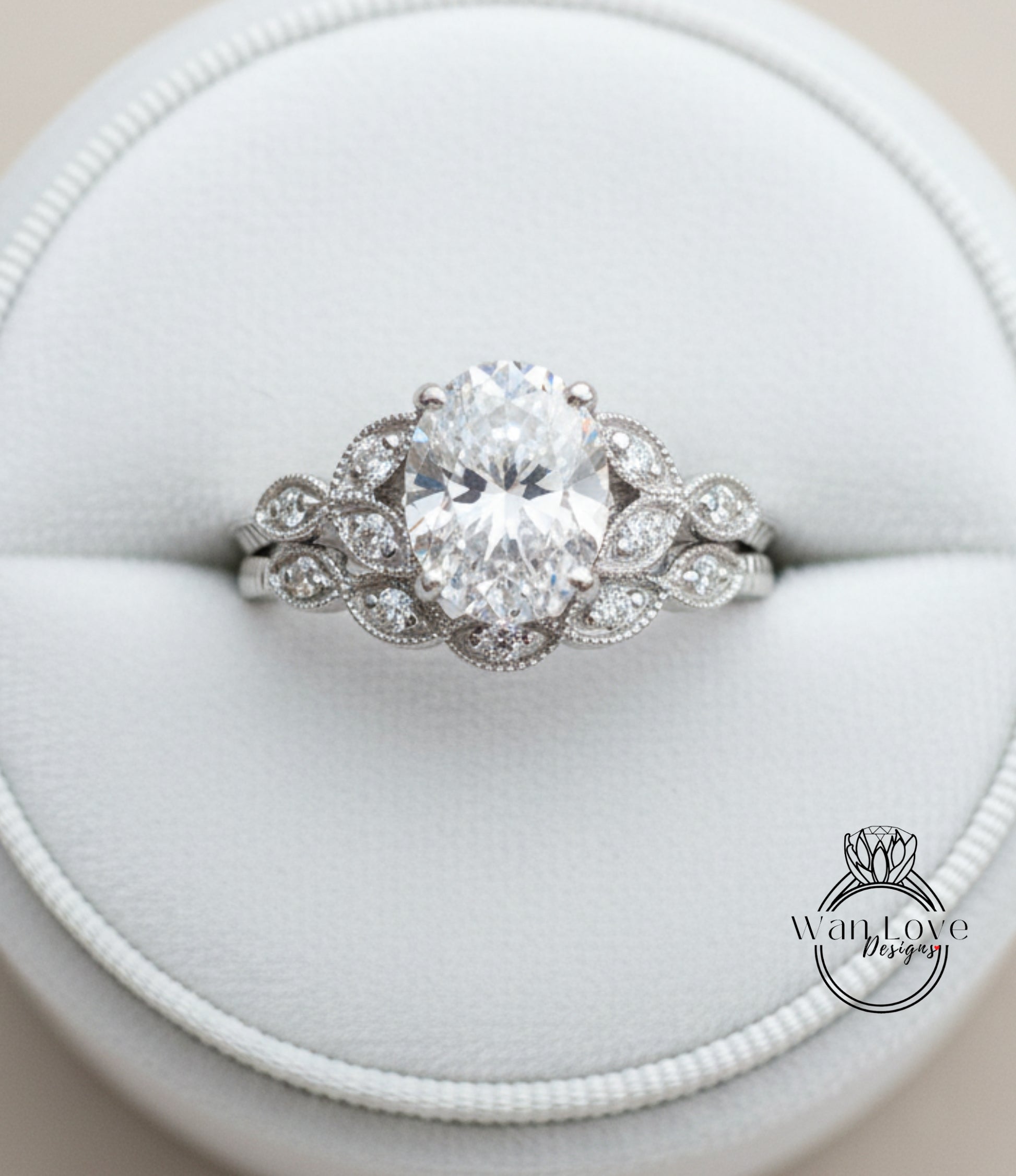 A close-up view of a diamond engagement ring displayed in a white jewelry box.