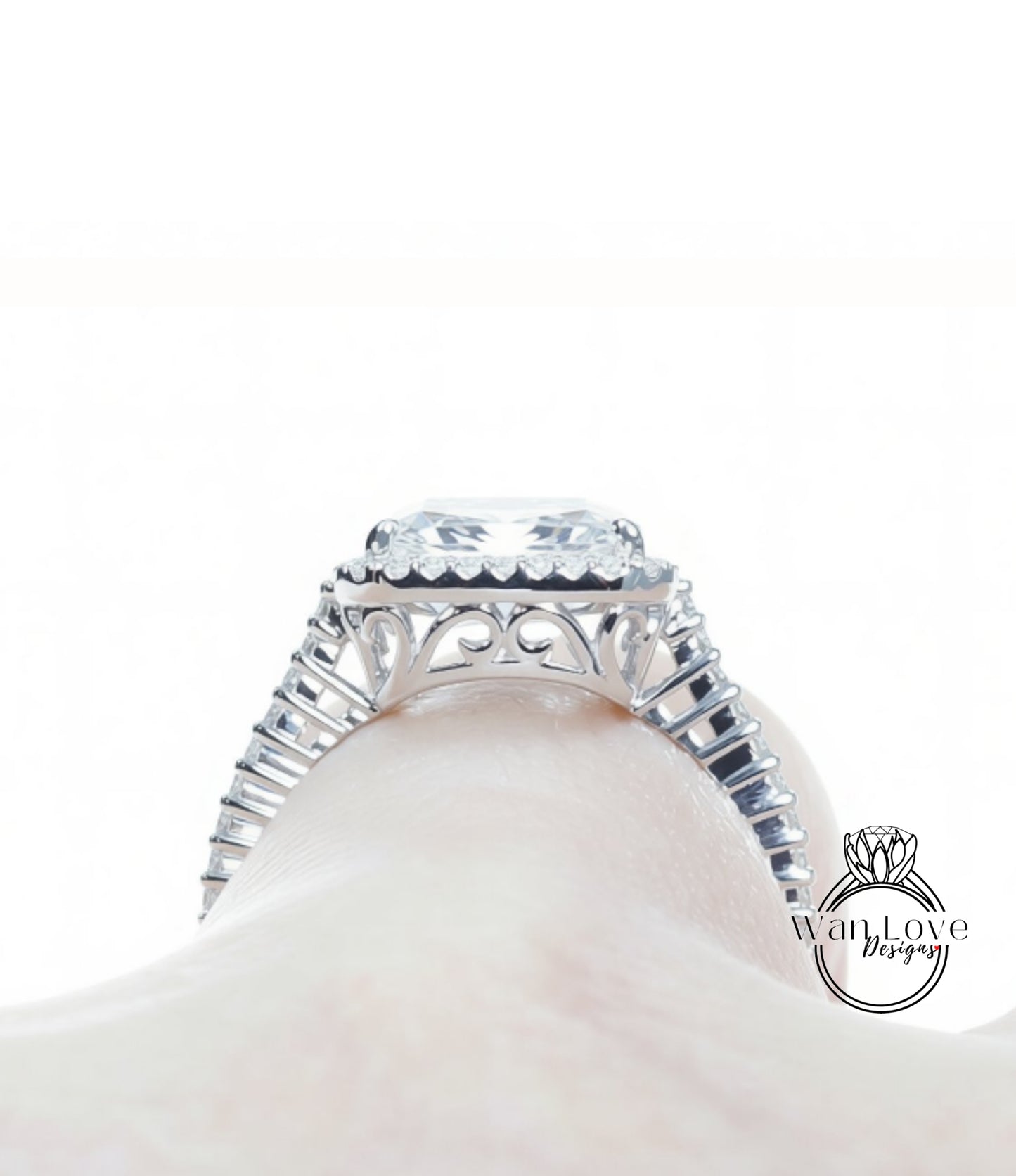 A close-up view of a diamond engagement ring on a person's hand, showcasing the intricate design and sparkling gemstone.