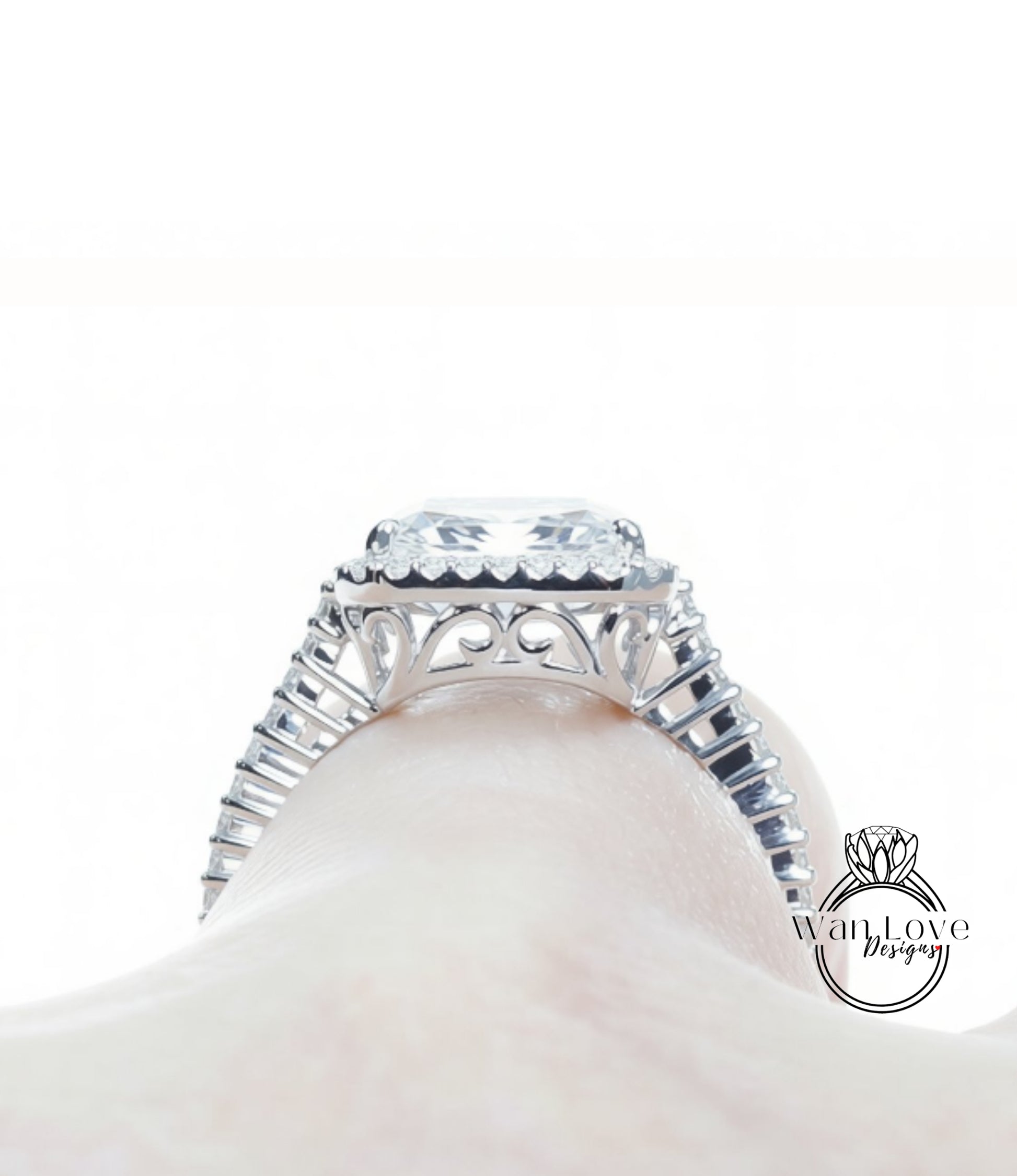 A close-up view of a diamond engagement ring on a person's hand, showcasing the intricate design and sparkling gemstone.