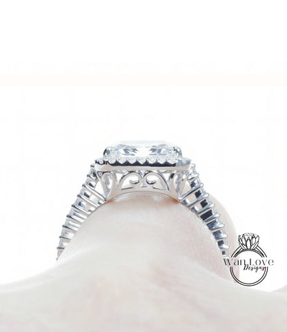 A close-up view of a diamond engagement ring on a person's hand, showcasing the intricate design and sparkling gemstone.
