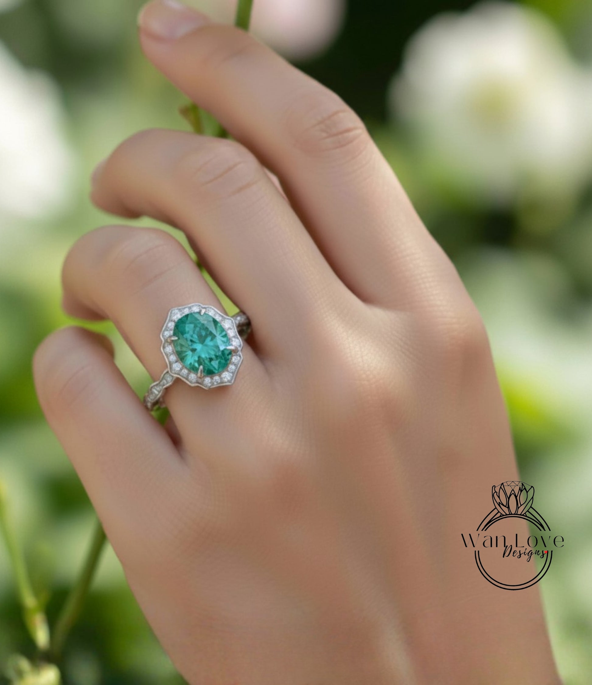A close-up of a hand wearing a ring with a large oval-shaped gemstone, likely a diamond, set in a halo of smaller diamonds.