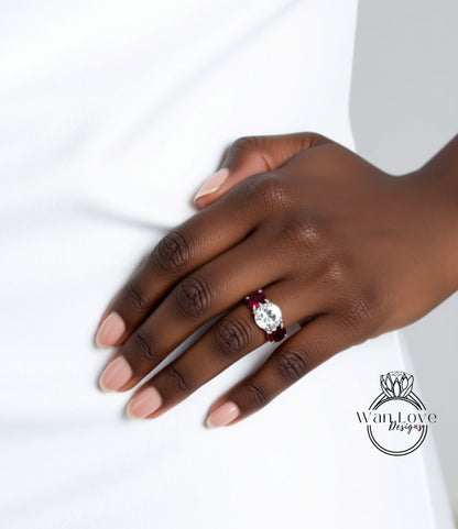 A close-up of a hand wearing a ring with a large diamond and a smaller diamond on the ring finger.