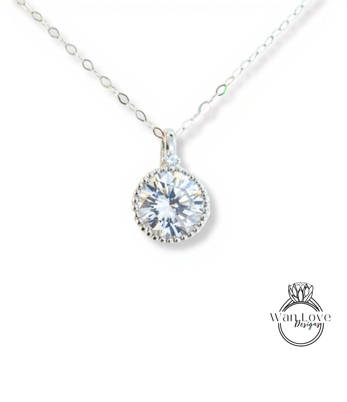 A close-up view of a delicate necklace with a large, round, brilliant-cut diamond pendant.