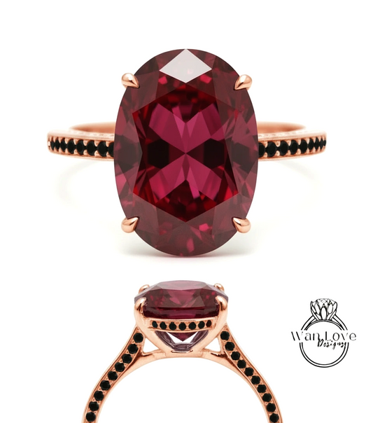 a large, oval-shaped, deep red gemstone ring with a rose gold band and a black diamond accent.