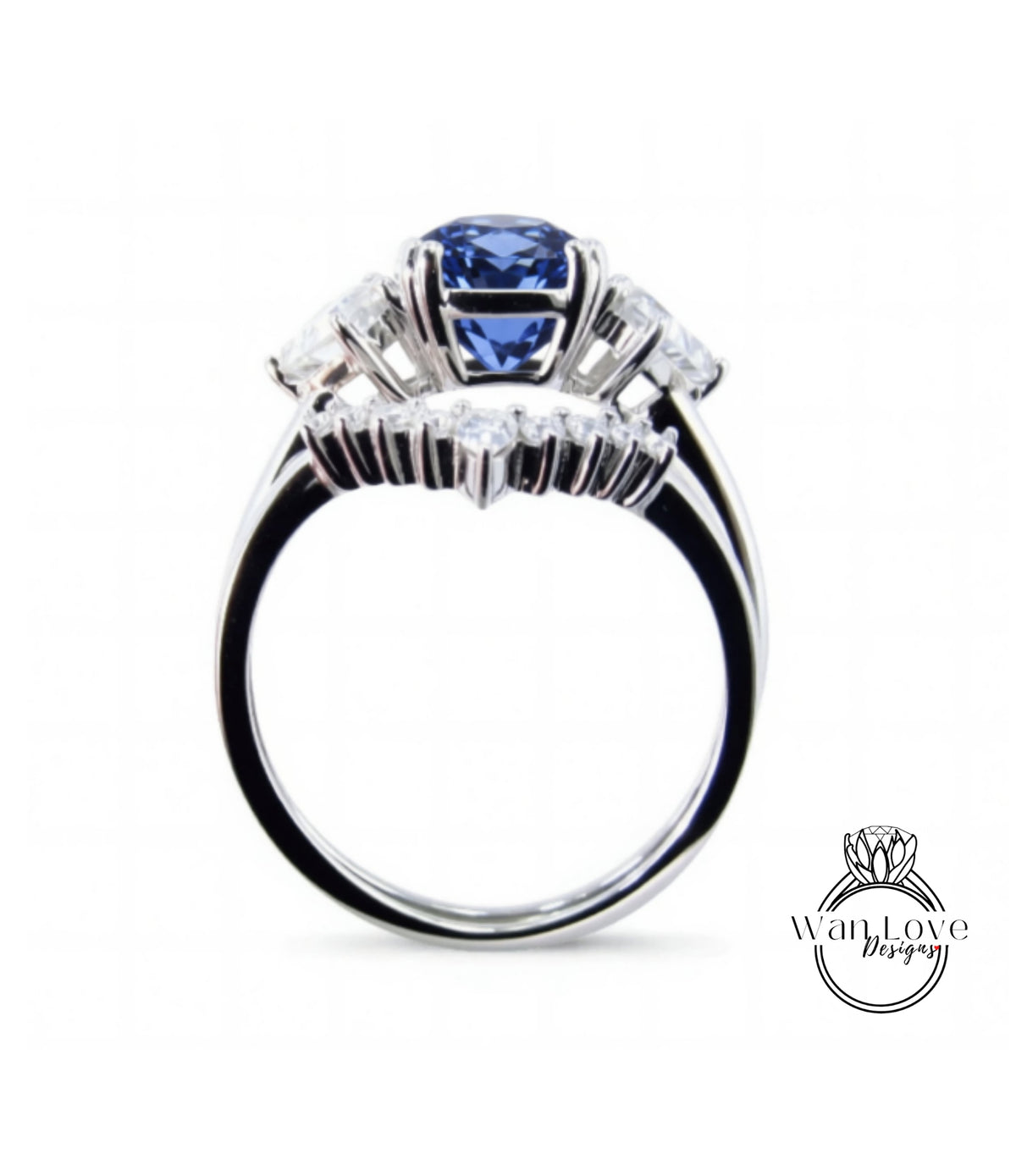 A silver ring with a large blue gemstone, likely a sapphire, surrounded by smaller diamonds.