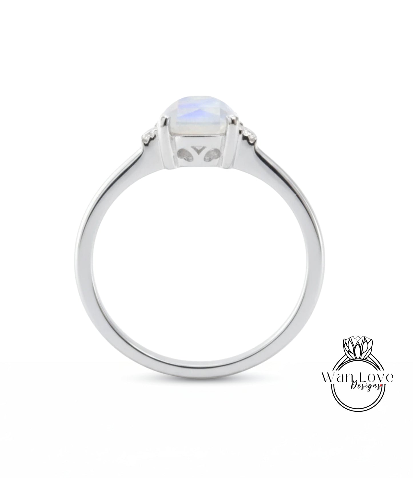 A silver ring with a large, clear gemstone in the center.