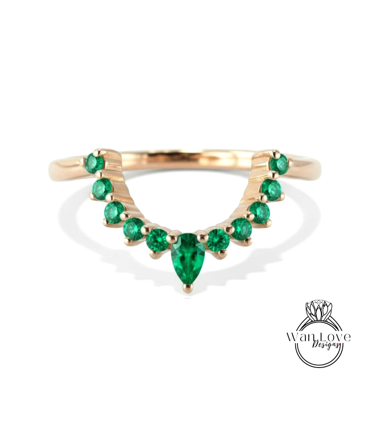 A gold ring with a large central green gemstone surrounded by smaller green gemstones arranged in a decorative pattern.
