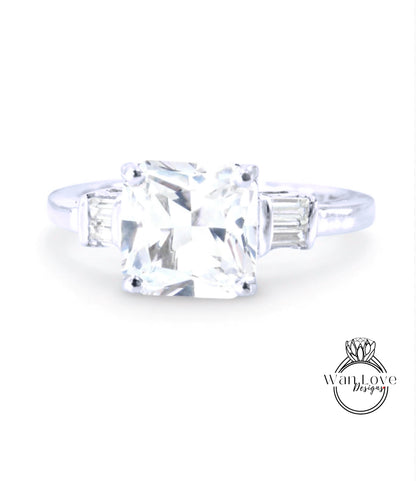 A diamond engagement ring with a large, clear gemstone set in a silver band.