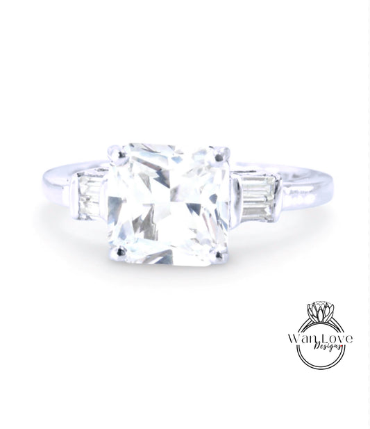 A diamond engagement ring with a large, clear gemstone set in a silver band.