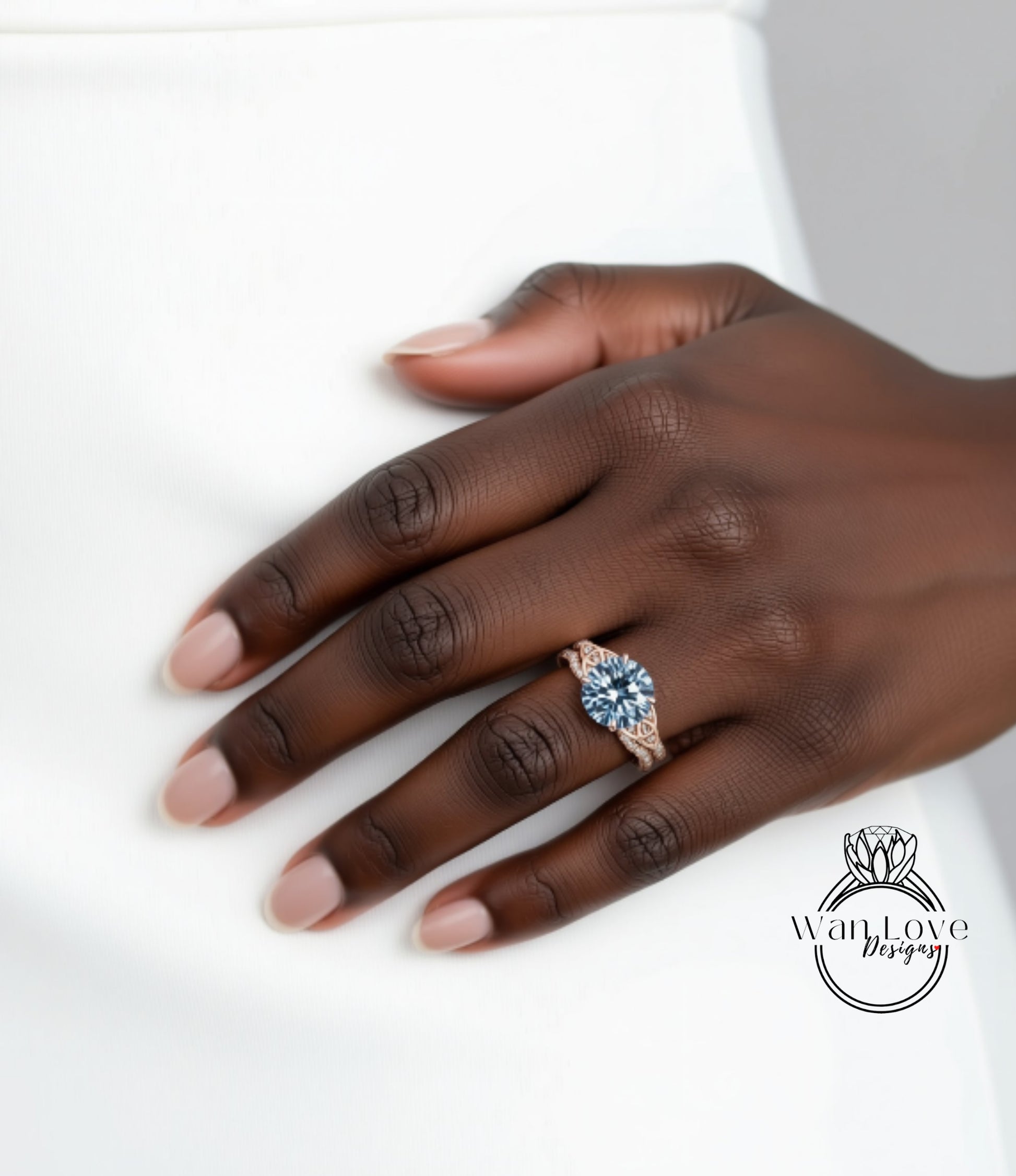 A close-up of a hand wearing a ring with a blue gemstone.