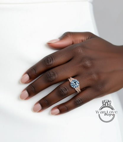 A close-up of a hand wearing a ring with a blue gemstone.