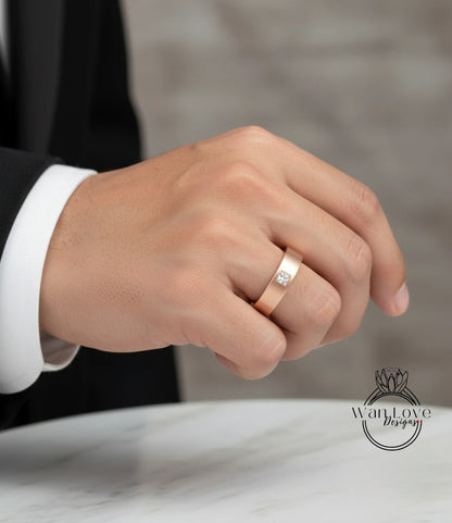 A close-up of a person's hand wearing a gold ring with a diamond.