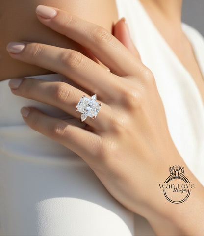 A close-up of a person's hand wearing a large diamond engagement ring.