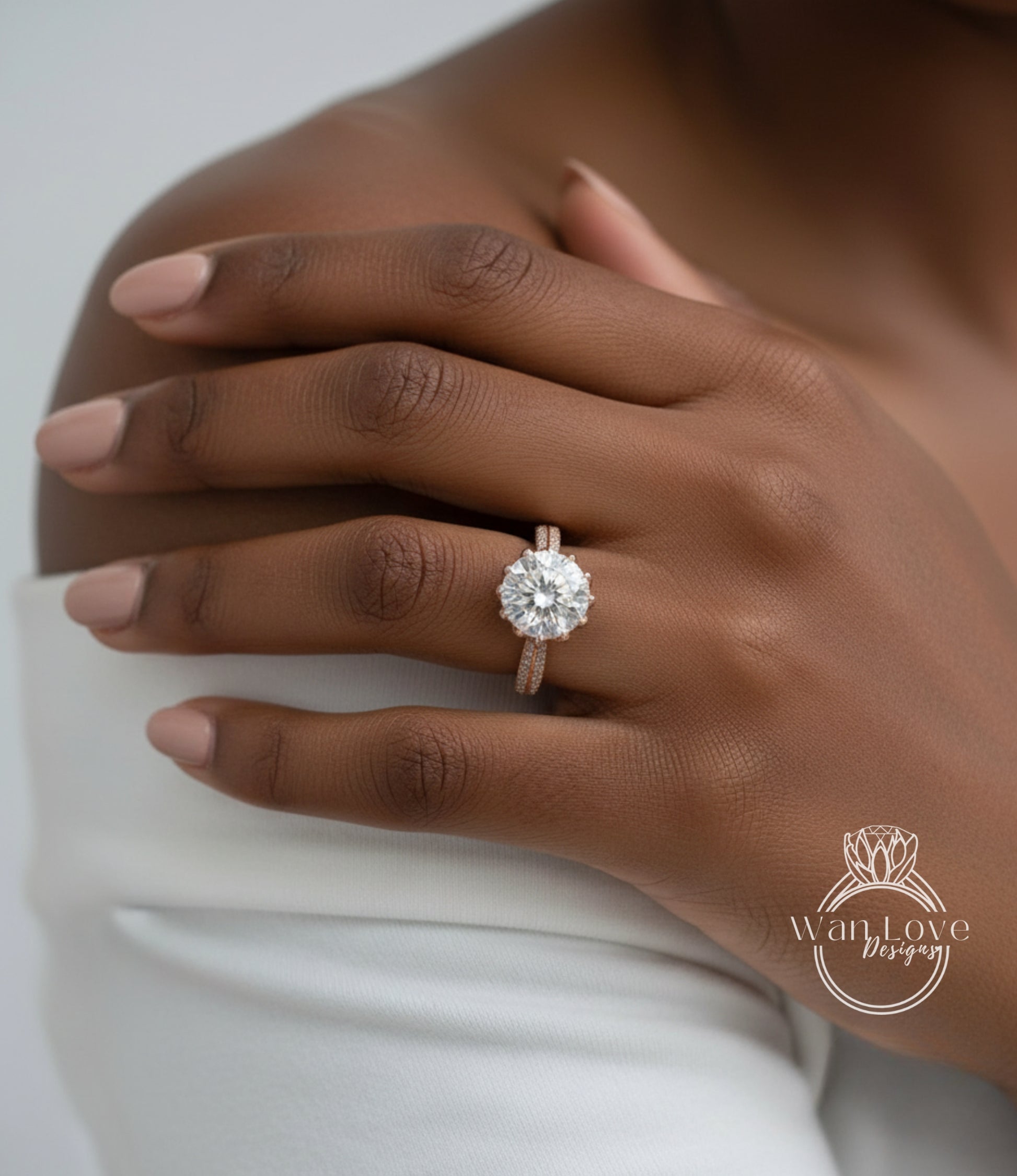 A close-up of a person's hand wearing a large, sparkling diamond engagement ring on the ring finger.