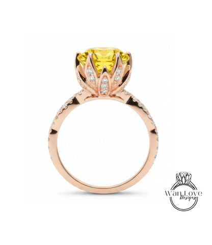 A gold ring with a large yellow gemstone, possibly a diamond, at the center, surrounded by smaller diamonds.