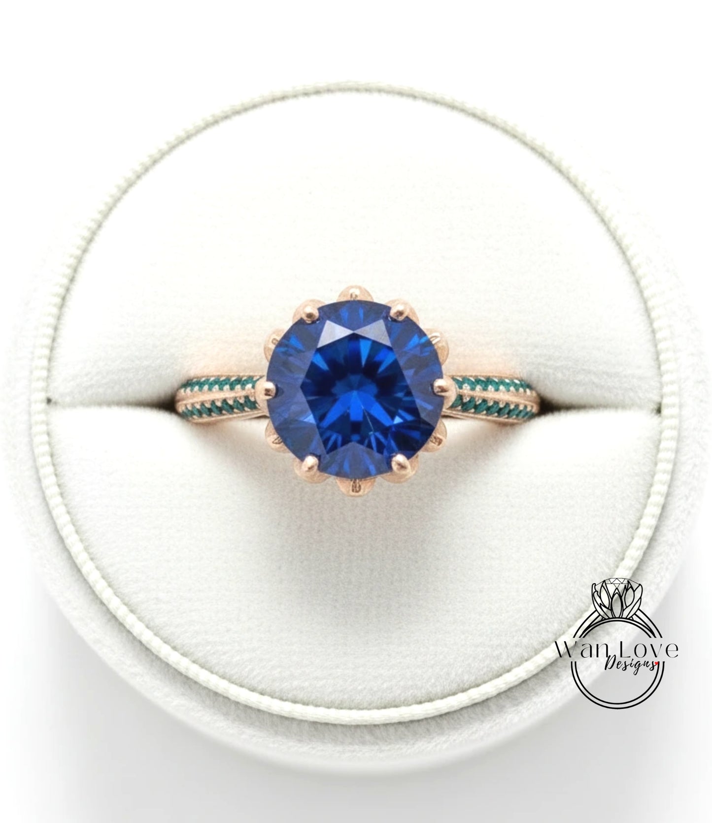A close-up view of a gold ring with a large blue gemstone, placed in a white jewelry box.
