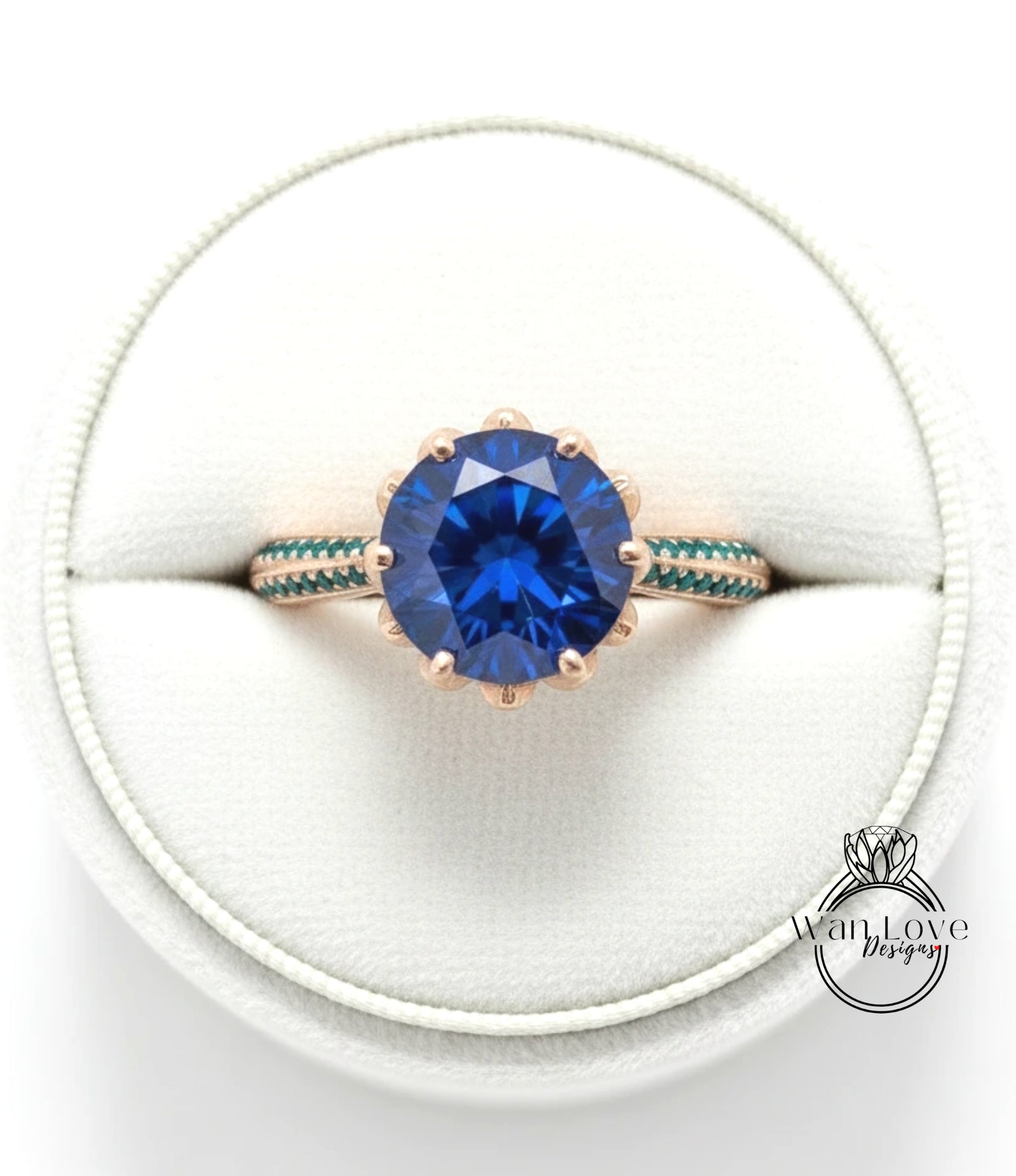 A close-up view of a gold ring with a large blue gemstone, placed in a white jewelry box.