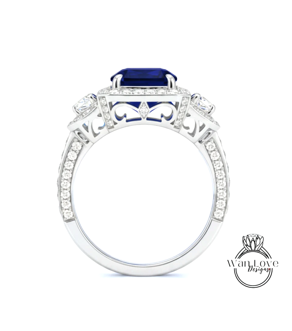 A silver ring with a large blue gemstone, surrounded by smaller diamonds and intricate designs.