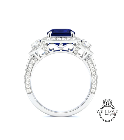 A silver ring with a large blue gemstone, surrounded by smaller diamonds and intricate designs.